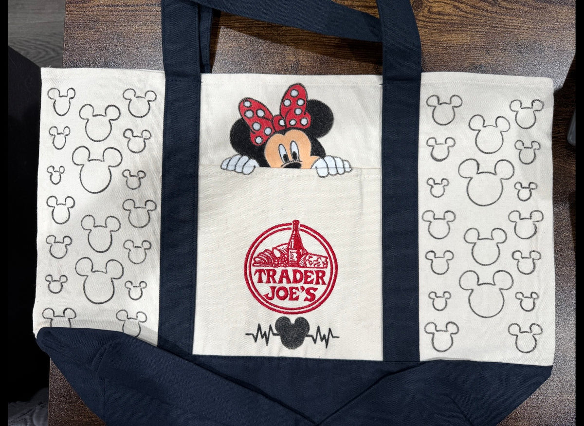Magical Minnie Mouse hand painted tote with Minnie peeking over the pocket and mouse ear outline pattern