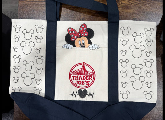 Magical Minnie Mouse hand painted tote with Minnie peeking over the pocket and mouse ear outline pattern