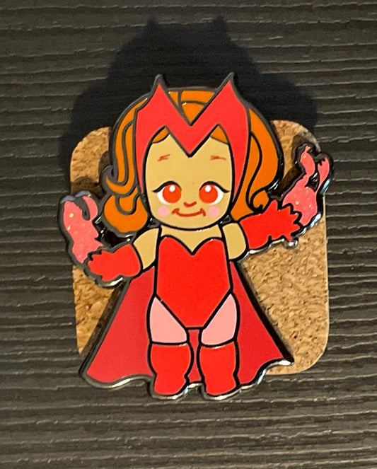 Red Magic Woman chibi enamel pin, red eye variant, with glitter pink hex magic on a cork board