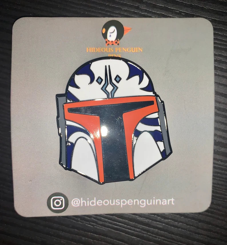 We’d Love to See It hard enamel pin, Mandalorian helmet with orange T visor and blue and white markings